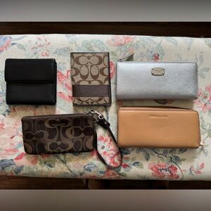 Lot of Authentic leather and fabric Michael Kors and Coach wallets.